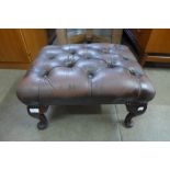 A brown leather footstool