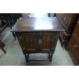 A small carved oak two door side cabinet