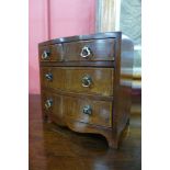 A Victorian apprentices miniature inlaid mahogany bow front chest of drawers