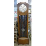 An Art Deco oak triple weight longcase clock