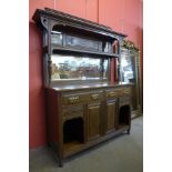 An Arts and Crafts oak mirrorback sideboard