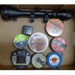 A collection of air rifle pellet tins with contents including Prometheus and a 3.9 x 50 scope