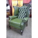 A green leather wingback armchair