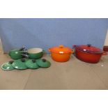 A set of four graduated green Le Creuset saucepans and two others