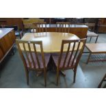 A Stag teak extending dining table and four teak dining chairs