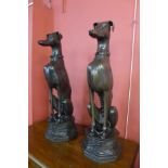 A pair of life sized bronze figures of seated whippets, 74cms h