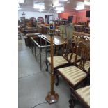 An Art Deco style brass and fruitwood floor standing lamp