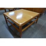 A teak square coffee table