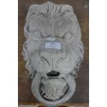 A concrete lion wall mask