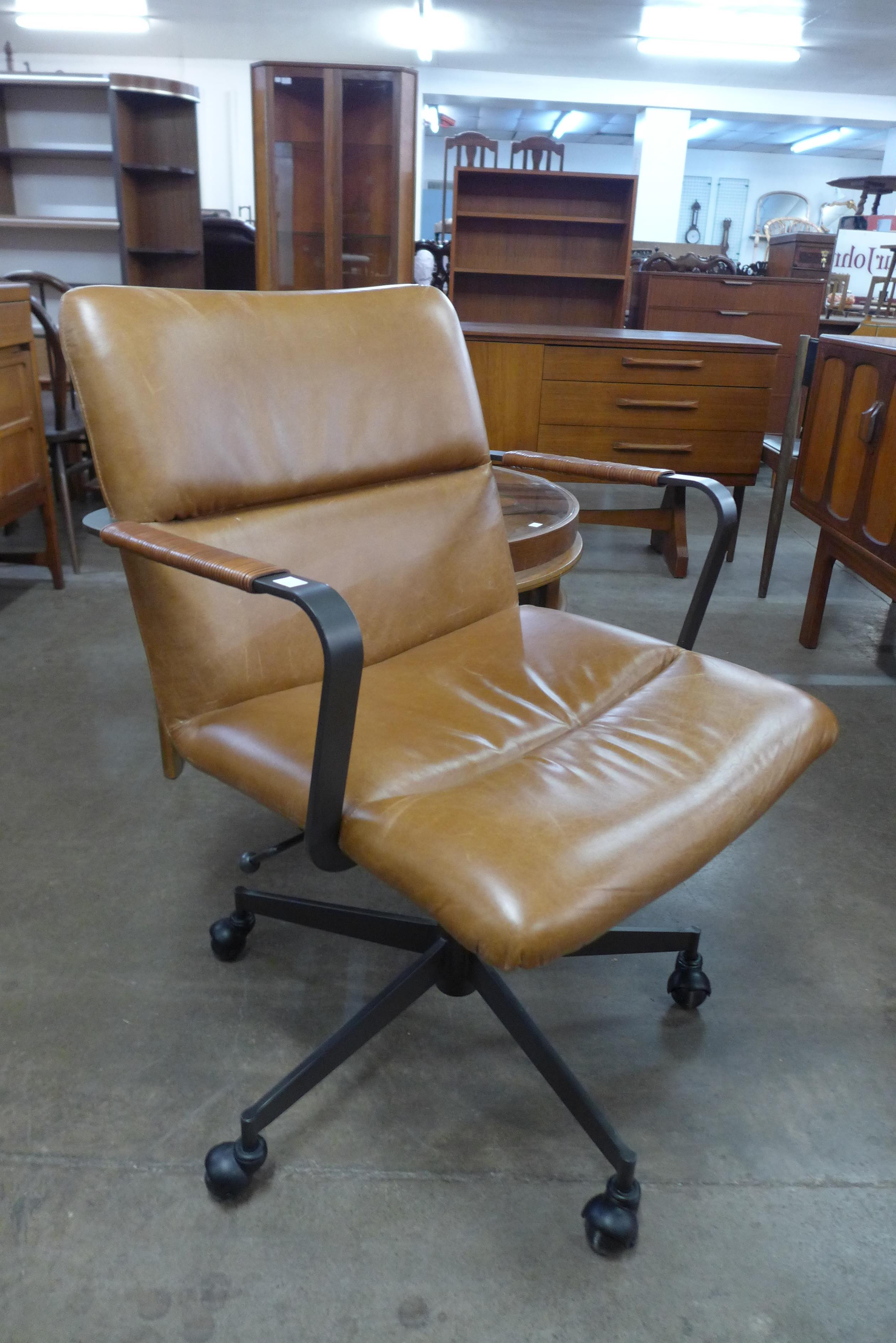 A black metal and brown leather revolving desk chair