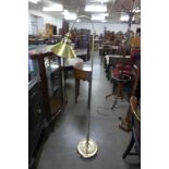 A brass effect floor standing anglepoise lamp