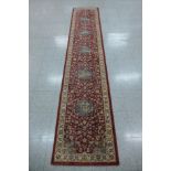 A red ground runner rug