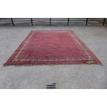A red ground geometric patterned rug, 453 x 356cms