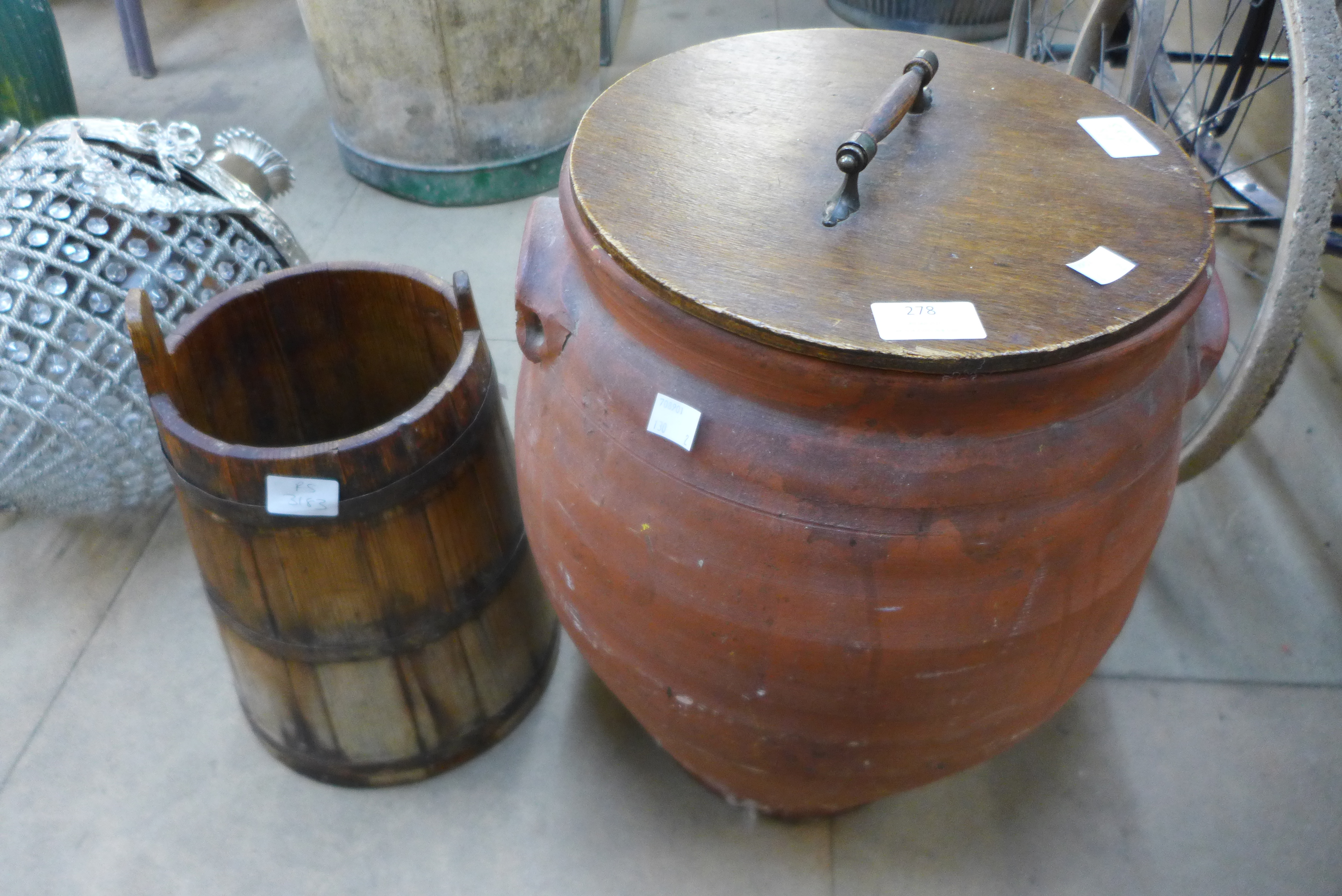 A terracotta lidded pot and a coopered pine churn