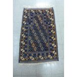 An eastern hand made blue ground prayer rug