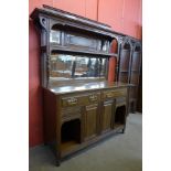 An Arts and Crafts oak mirrorback sideboard