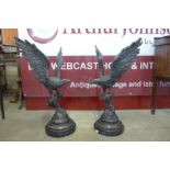 A pair of large bronze figures of eagles, on black marble socles, 90cms h