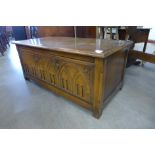 A Gothic Revival carved oak blanket box