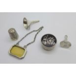 A silver and ivory spirit label (London 1929), silver miniature funnel, pill box, etc.