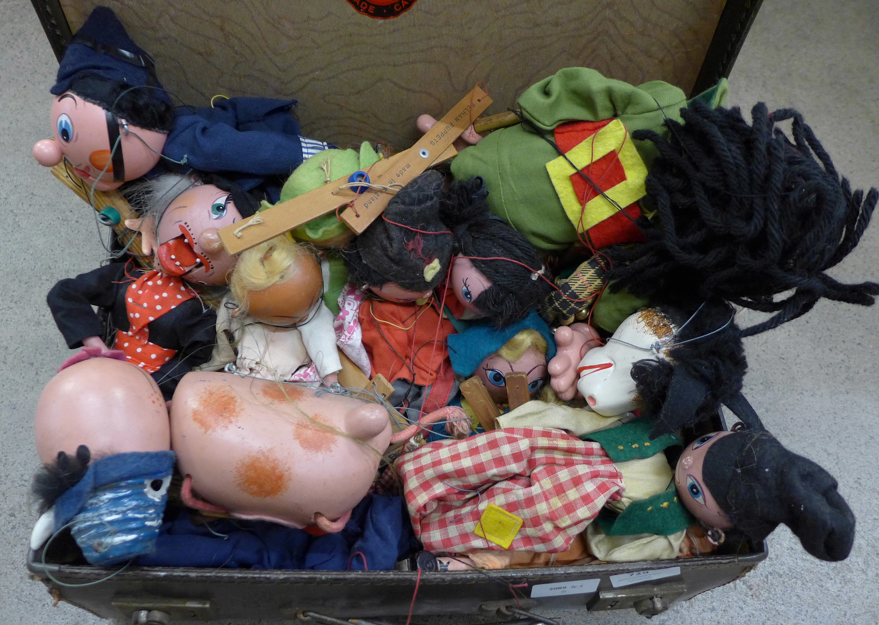 A suitcase containing a collection of fourteen Pelham puppets