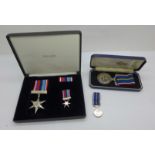 A National Service Medal and a For Crown and Country Medal with miniature