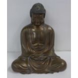 A bronzed plaster filled model of Buddha, 25cm