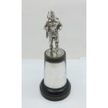 A silver figure of a soldier on an ebonised base with silver plaque, 153mm