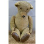 A straw filled Teddy bear, missing one eye, 72cm