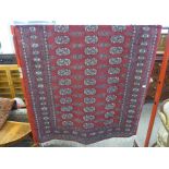 A Pakistani Bokhara red ground rug and one other