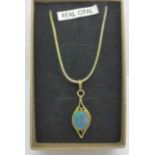 An opal pendant on a silver gilt chain