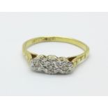 An 18ct gold, platinum set three stone diamond ring, 1.8g, L