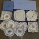 Two boxes of four Wedgwood Symphony Christmas plates and two Wedgwood cake stands, boxed