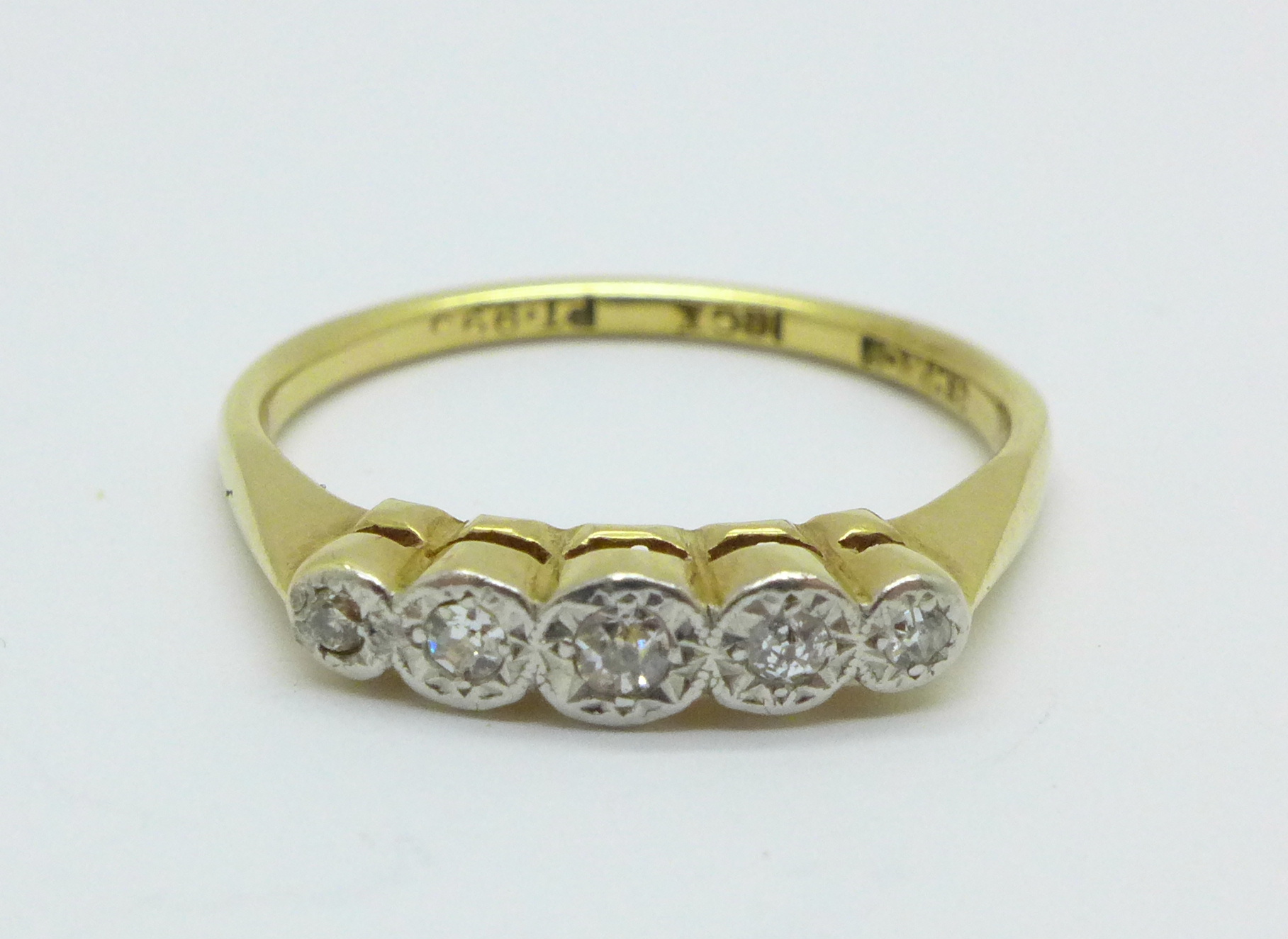 An 18ct gold, platinum set five stone diamond ring, 2.6g, N