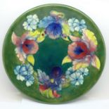 A Moorcroft Orchid pattern plate, signed on the base, 26cm