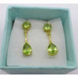 A pair of silver gilt and peridot drop earrings