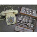 A vintage telephone and a gentleman's travelling vanity set