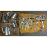 A collection of silver plated spoons and other flatware, two silver plated teapots including