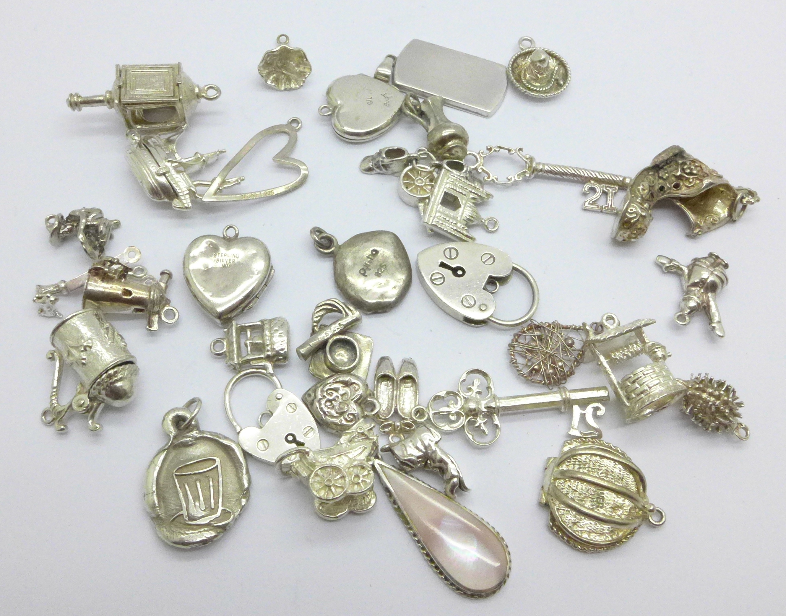 A collection of silver and white metal charms, total weight 83g, one locket marked 'SIL BK-FT'