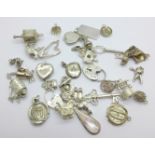 A collection of silver and white metal charms, total weight 83g, one locket marked 'SIL BK-FT'