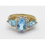 A 9ct gold ring set with three blue stones and four small diamonds, 2.6g, P