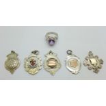 Five silver fobs including two with gold applied decoration and a silver ring, R