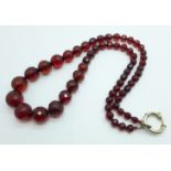 A long string of sherry amber coloured faceted beads