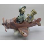 A Lladro figure, Boy and Girl Looking Down from Aeroplane, boxed