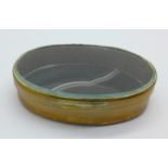 An oval box with agate set base and glass top, 7cm
