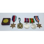 Four WWII medals, a Victorian commemorative medal and Queen Elizabeth II Coronation souvenir