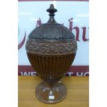 A George III style carved mahogany urn and cover, manner of Robert Adams, 68cms h