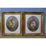 A pair of oval still life's of flowers, oil on board, framed