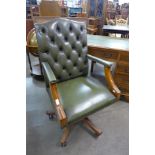 A mahogany and green buttoned leather desk chair