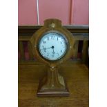 An Art Nouveau inlaid mahogany mantel timepiece