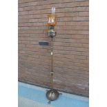 An Arts and Crafts brass and copper telescopic floor standing oil lamp